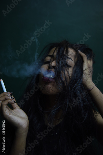 Sexy black woman smoking a cigarette
