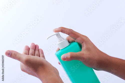 Man wash their hands with alcohol gel to prevent the spread of infections corona virus along with avoiding bacteria. Isolation on white background with clipping path.