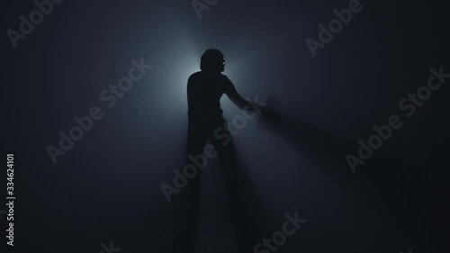 A burglar with a sack and flashlight