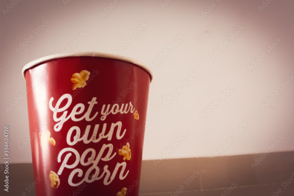 Bright red pop corn bucket in selective focus Bright red pop corn bucket in selective focus