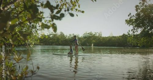 Mother and daughter paddle boarding