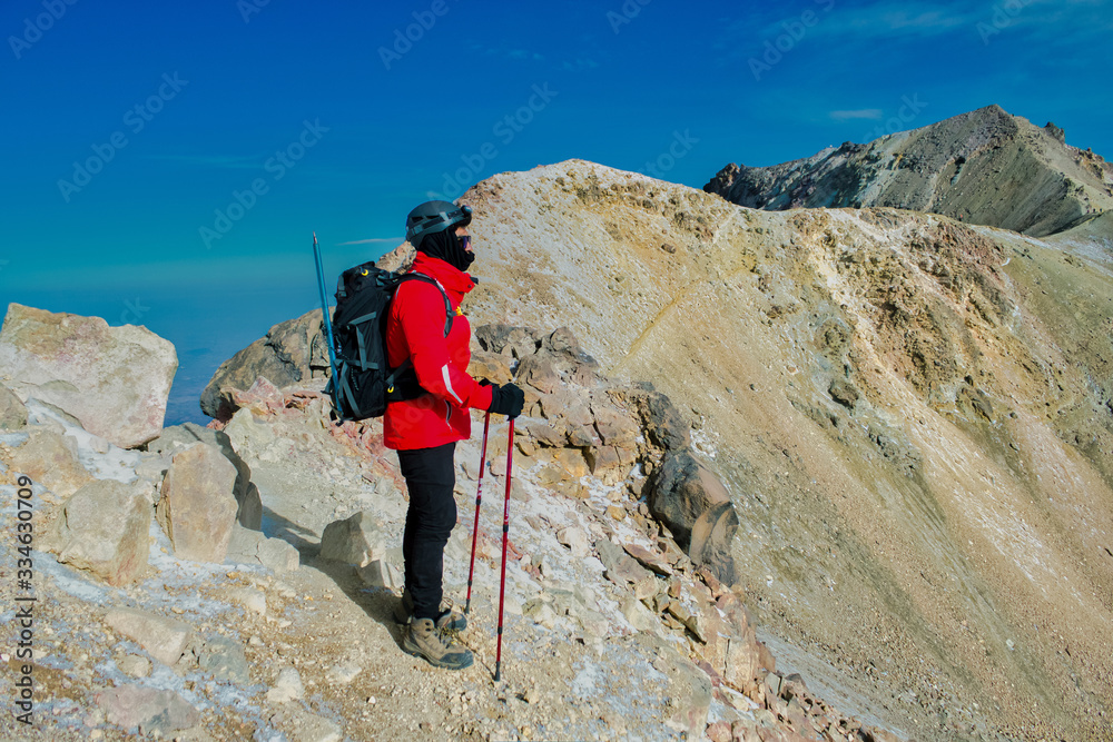 Hiker trekking in the mountains. hiker observes the orizonte in the chasm of the Iztaccihuatl volcano Popocatepetl National Park, Mexico. concept Sport and active life.