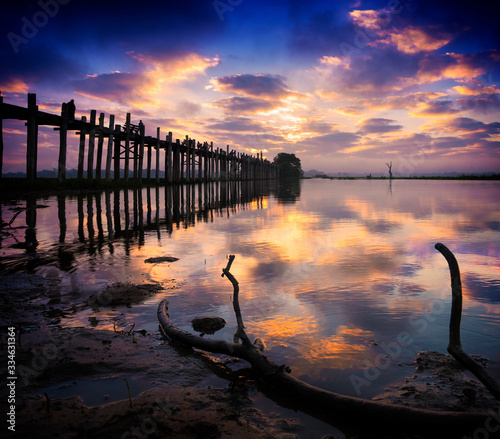 The silhouette of longest teak bridge U Bein at Sunrise, Mandalay, Myanmar photo