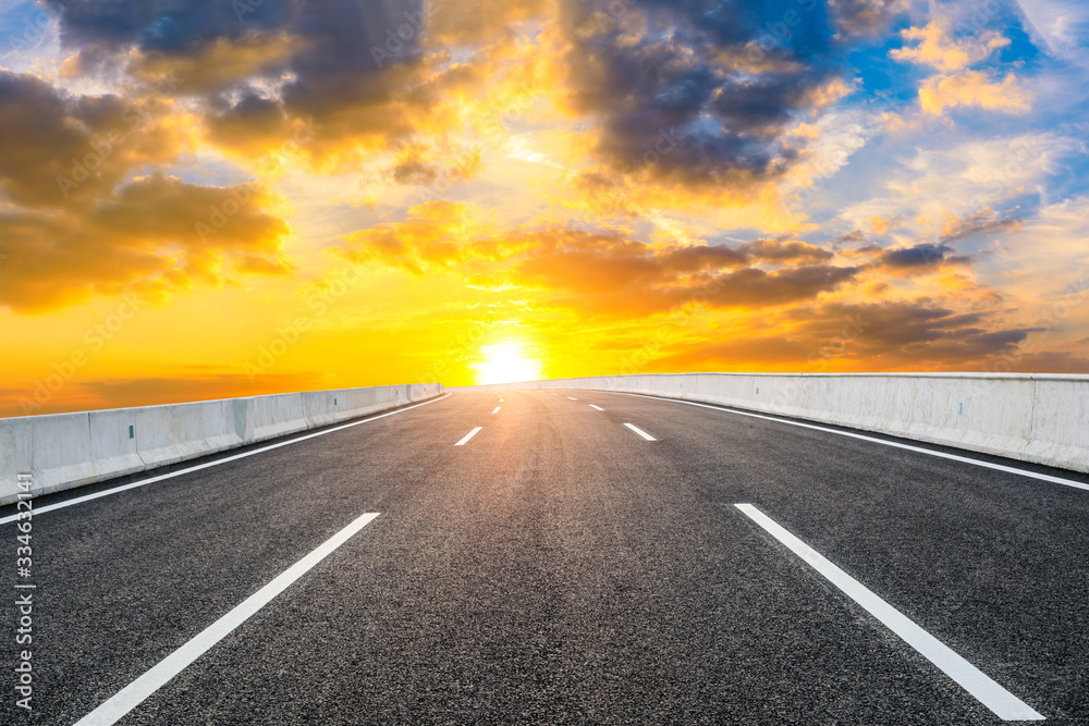 Fototapeta premium Asphalt highway road and sky sunset clouds landscape.