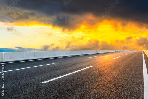 Asphalt highway road and sky sunset clouds landscape.