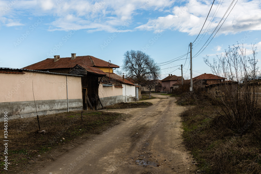 View of road and houses in small village View of road and houses in small village