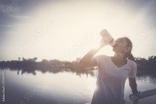 Healthy woman doing exercises and warm up before running and jogging on bridge at morning © only_kim