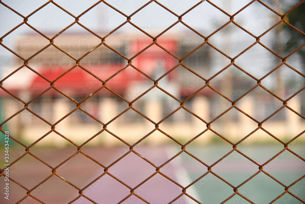 Beautiful view of Background texture of old rusty wire mesh. Cut off picture, horizontal, place for text, no people. Conception of construction and safety at sunset. Selected focus Beautiful view of Background texture of old rusty wire mesh. Cut off picture, horizontal, place for text, no people. Conception of construction and safety at sunset. Selected focus
