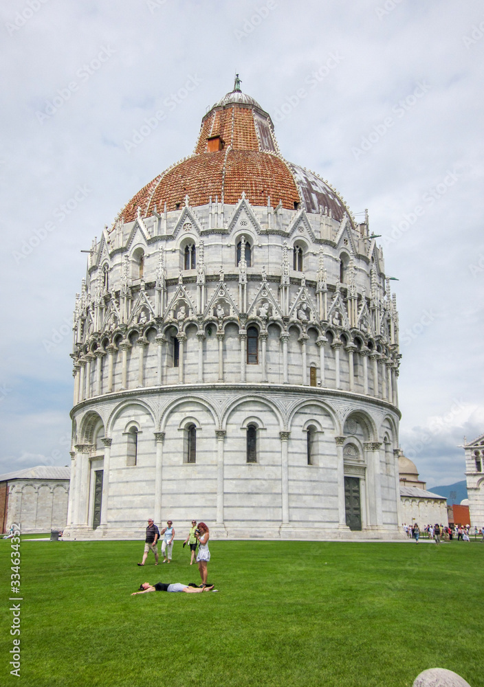 A shot of the The Pisa Baptistery of Saint John with tourists