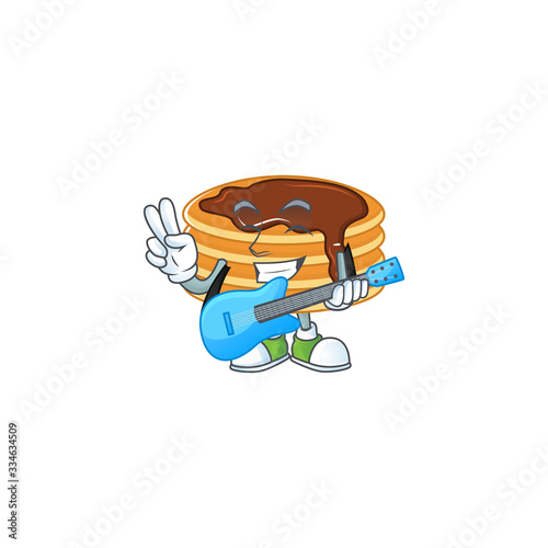 Happy face of chocolate cream pancake cartoon plays music with a guitar