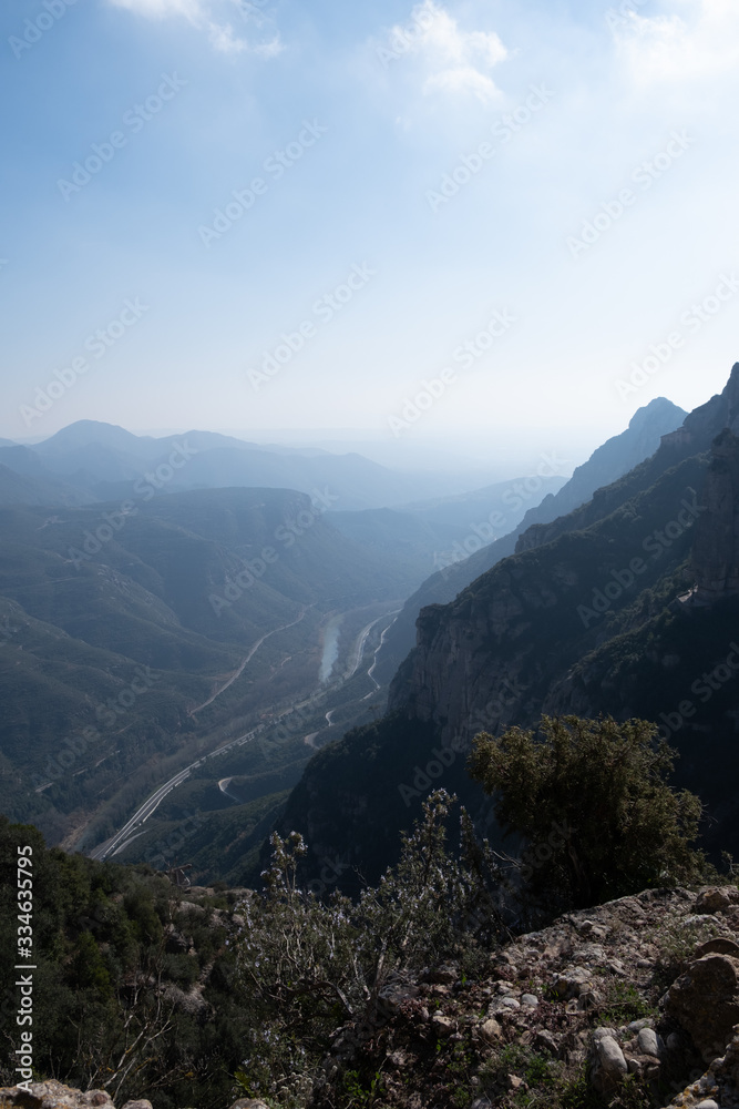 Obraz premium Beautiful Mountain panorama view. Lovely scenery landscape with blue sky, stones, trees, hills and valley.