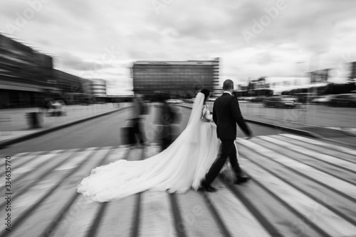 bride and groom on pedestrian crossing photo