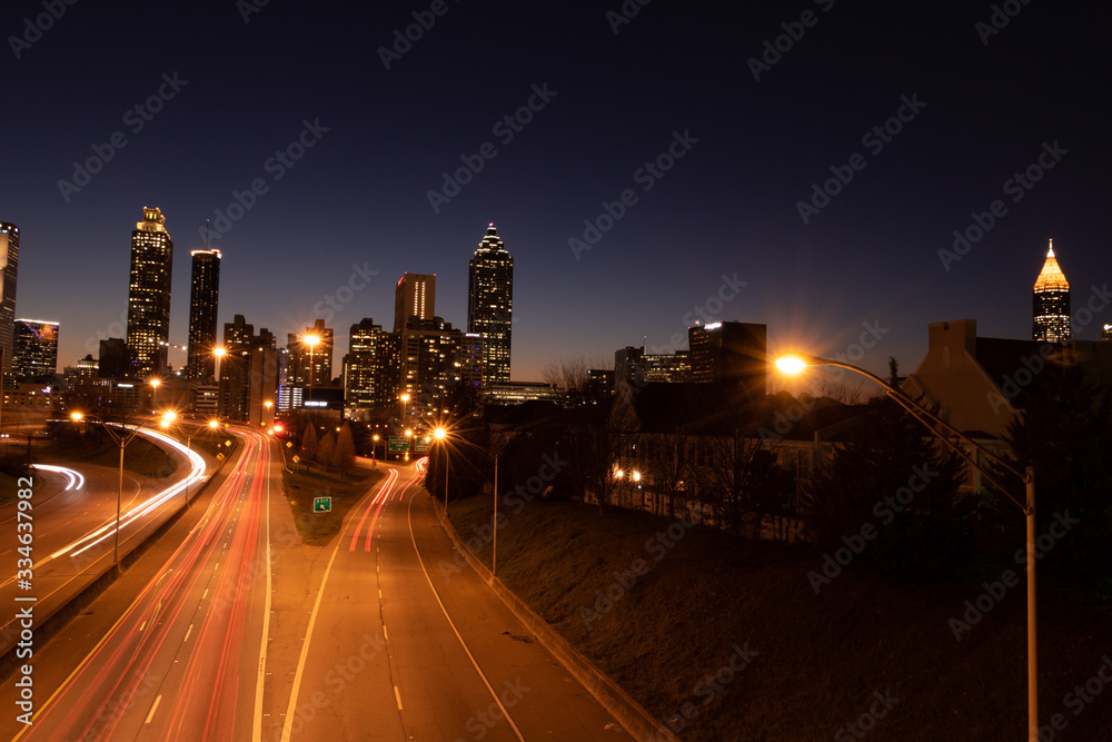 car trails at night in city skyline