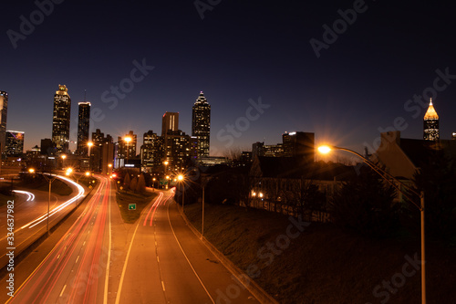 car trails at night in city skyline