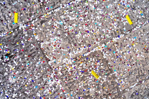 Color confetti on the ground after carnival or party. Background or texture.