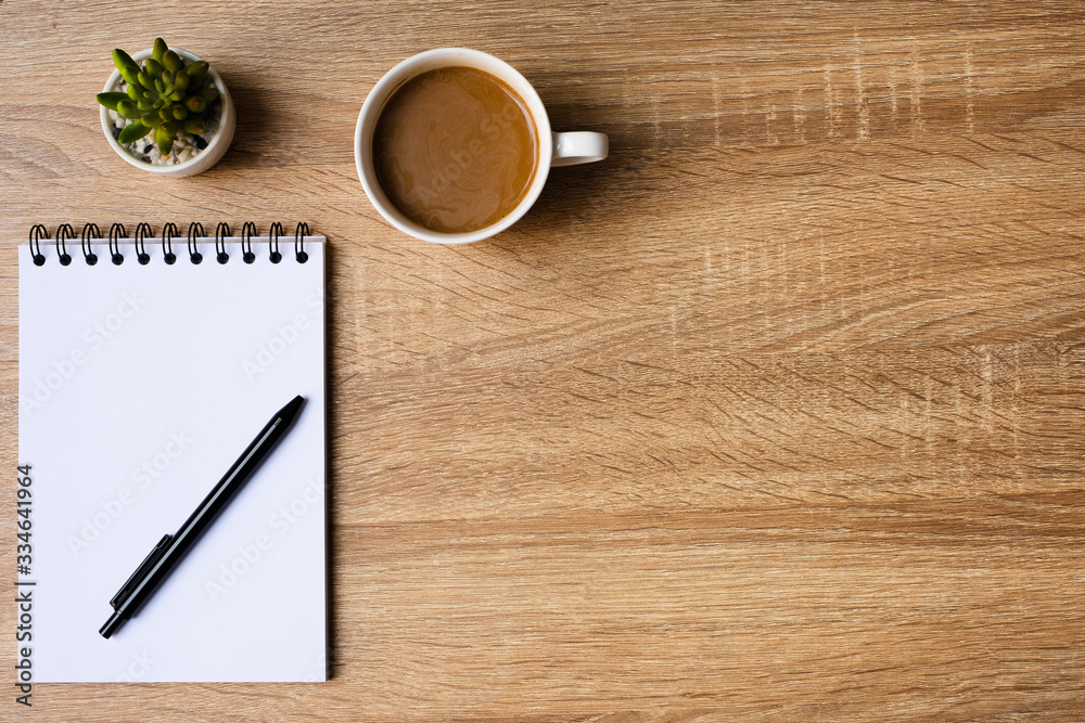 desk office with laptop, blank notepad, coffee cup and pen on wood table. Flat lay top view copy spce. desk office with laptop, blank notepad, coffee cup and pen on wood table. Flat lay top view copy spce.