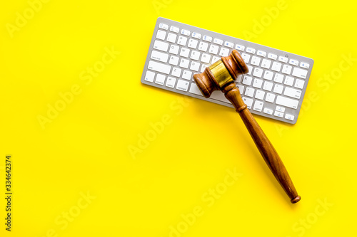 Judge gavel and keyboard - lawyer concept - on yellow background top-down copy space