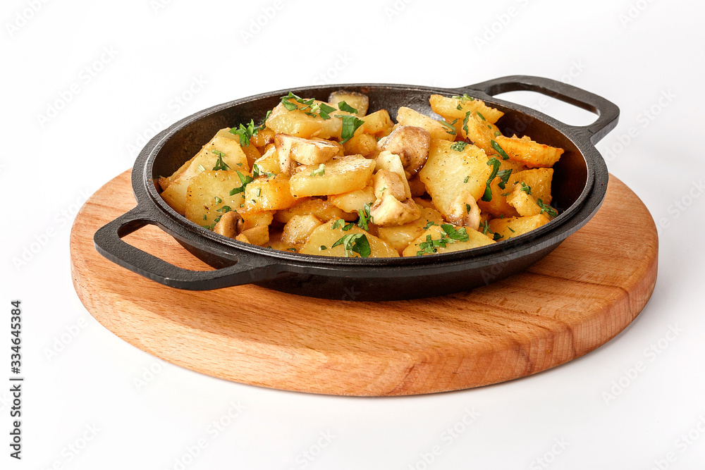 Chips with mushrooms on a cast-iron skillet on a wooden tray Isolated on a white background. Chips with mushrooms on a cast-iron skillet on a wooden tray Isolated on a white background.