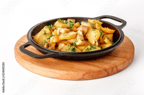 Chips with mushrooms on a cast-iron skillet on a wooden tray Isolated on a white background.