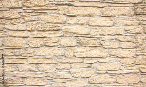 Texture of stone wall, square yellow travertine tile.