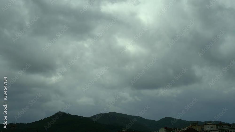 Timelapse of low clouds passing over the mountains next to the city in the afternoon. Timelapse of low clouds passing over the mountains next to the city in the afternoon.