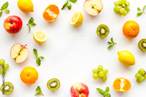 Colorful fruit mockup. Cut apple, kiwi, citrus on white background top-down copy space