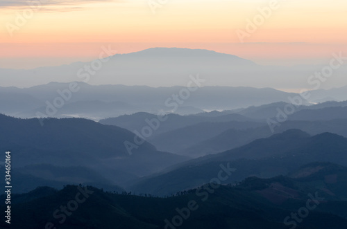 Layer of mountains and mist during sunset © Zakiraz