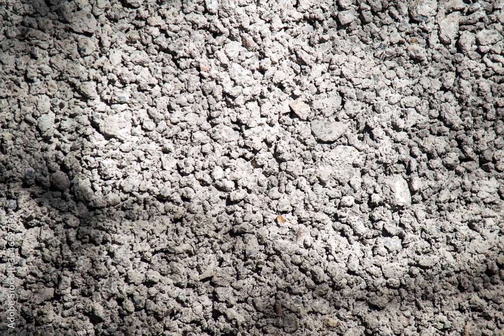 The texture of the concrete fence is gray