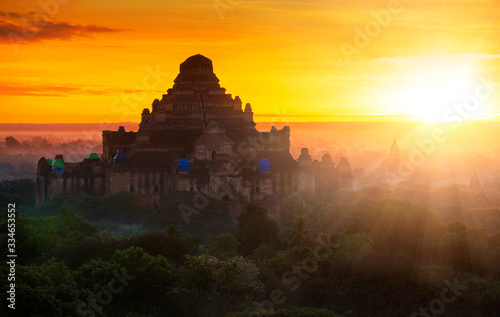 Pagoda landscape of Bagan in misty morning under a warm sunrise in the plain of Bagan