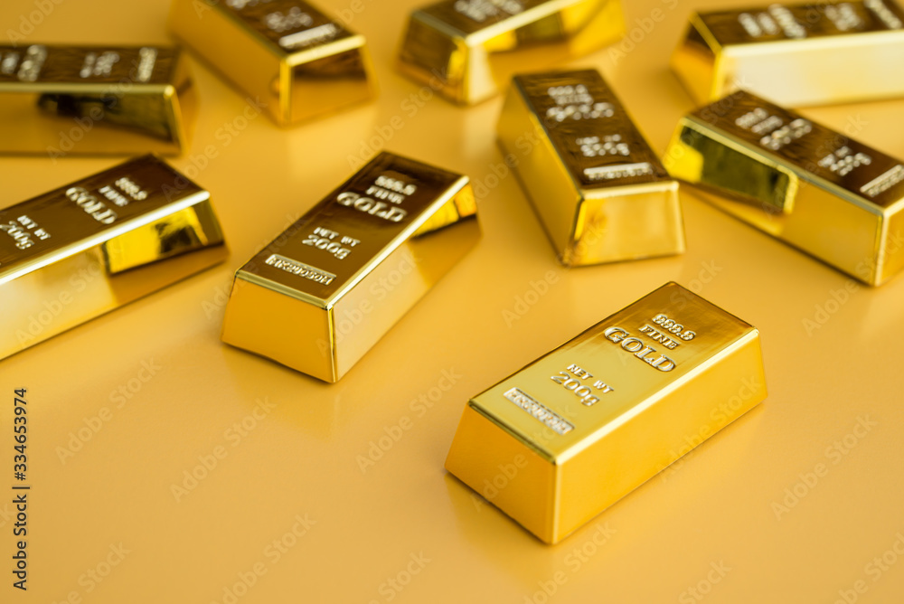 Gold bars or bullion on yellow background. Financial, global world economic or gold trading in commodity market concept. It performs well during global crises. Gold bars or bullion on yellow background. Financial, global world economic or gold trading in commodity market concept. It performs well during global crises.