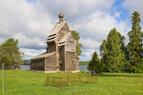 View of the ancient wooden church of St. George the Victorious on the Yuksovsky graveyard on a August day. Rodionovo, Leningrad region. Russia photo