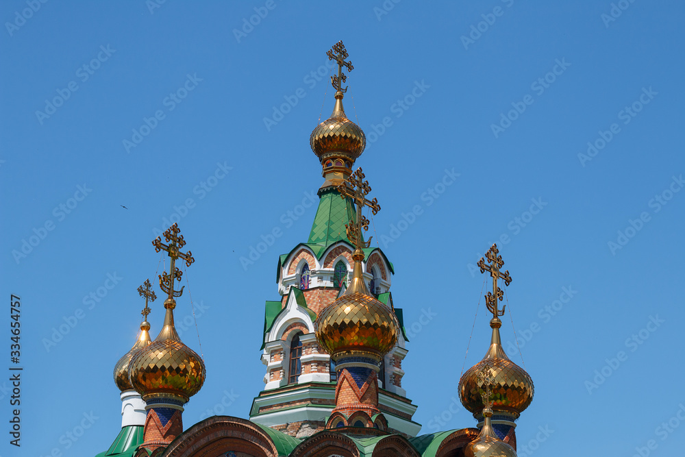 Golden domes with crosses of the temple