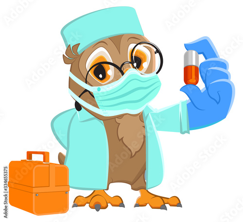 Owl doctor in medical mask holds pill medicine. Coronavirus protection medical mask