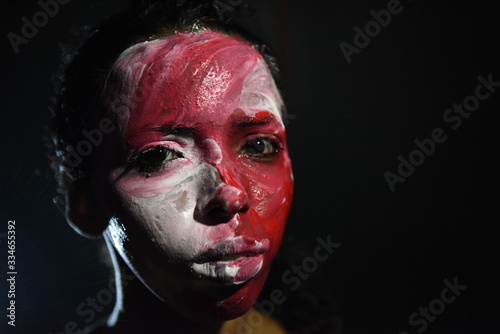 Beauty model girl with colorful paint on her face