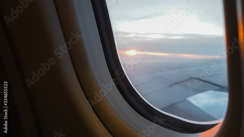 Beautiful scenic city view of sunset through the aircraft window