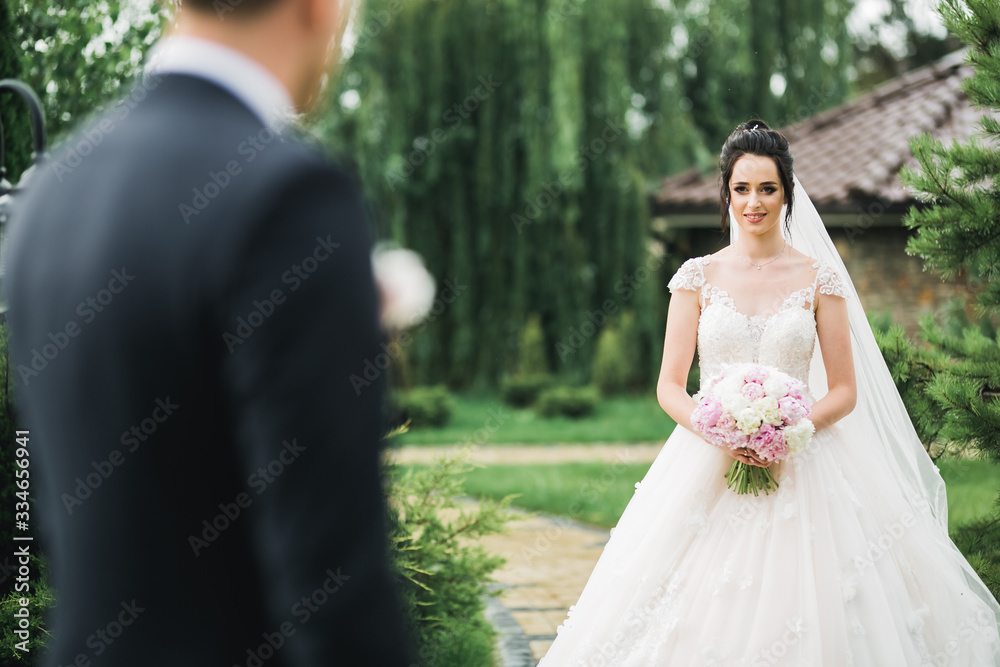 Gorgeous happy couple standing close to each other and looking in eyes
