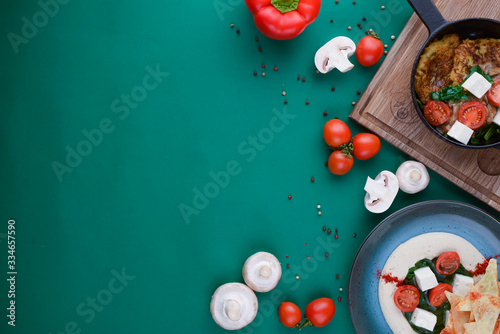 Raw ingredients for pizza or salad. Tomatoes, mushrooms on green background. Flat lay. Web design banner with copy space