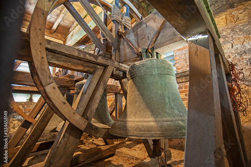 Large old bells in a church tower photo