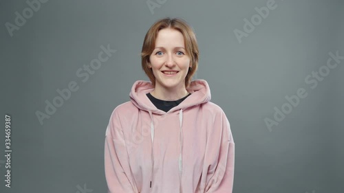 Video of young agree woman in pink sweatshirt
