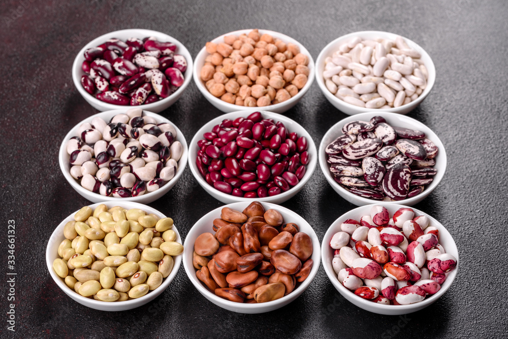 Pulses health food selection in white porcelain dishes over concrete background Pulses health food selection in white porcelain dishes over concrete background