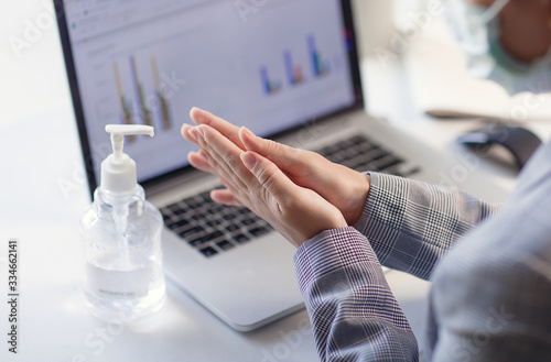 Fotografi Woman hands using hand alcohol gel or sanitizer bottle dispenser, against corona virus Covid-19