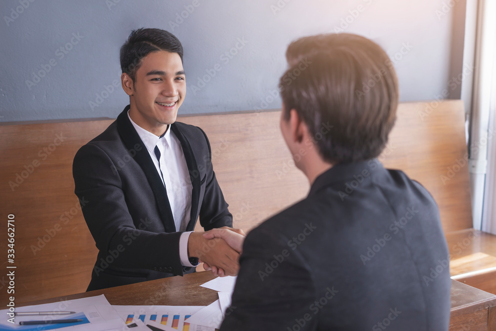 businessmen smiling and firmly shaking each other’s hands on agreement deal decision making, formally and smartly dressed wearing a suit and tie with white shirt having a meeting interview together businessmen smiling and firmly shaking each other’s hands on agreement deal decision making, formally and smartly dressed wearing a suit and tie with white shirt having a meeting interview together