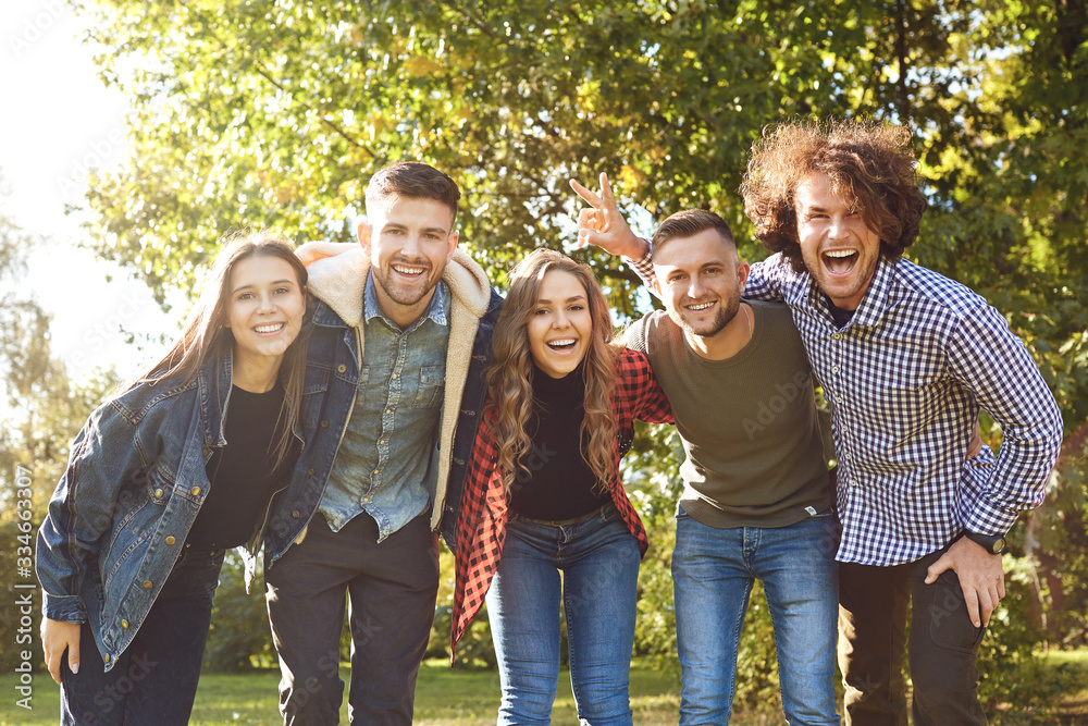 Group of happy friends are walking in the park.