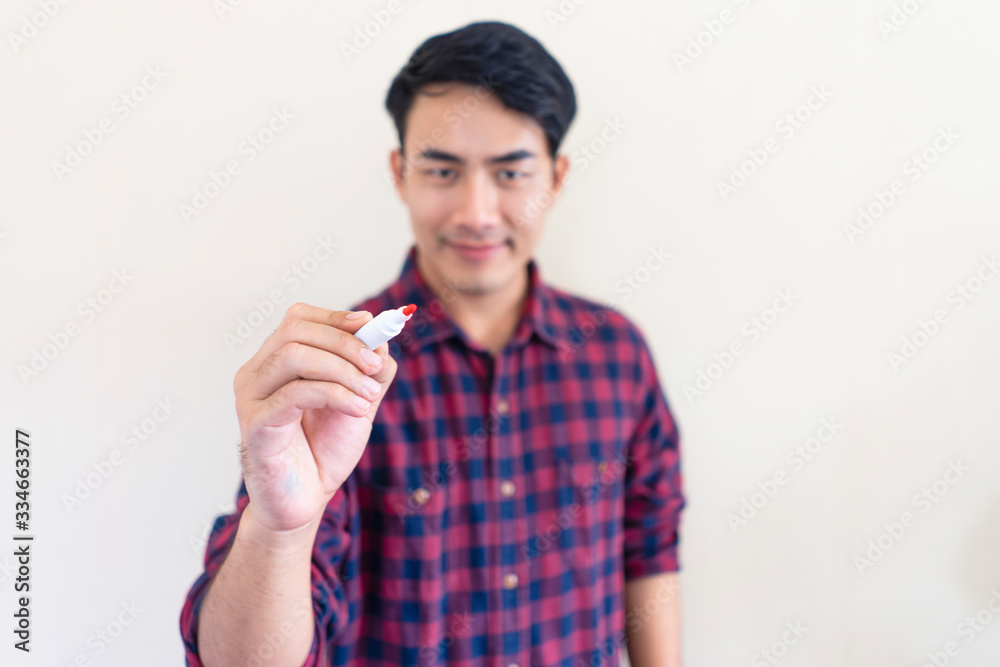 isolated concept of asian male holding a whiteboard marker pointing towards and about to write, representing working, planning, taking down ideas within a company or personal business presentation isolated concept of asian male holding a whiteboard marker pointing towards and about to write, representing working, planning, taking down ideas within a company or personal business presentation