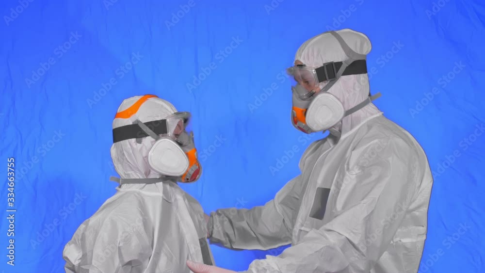 Doctor man and woman in protective costume suit, gas protect medical spray paint mask. Love couple kiss and hug, health worker in respirator. Health virus protection coronavirus epidemic covid-19. Doctor man and woman in protective costume suit, gas protect medical spray paint mask. Love couple kiss and hug, health worker in respirator. Health virus protection coronavirus epidemic covid-19.