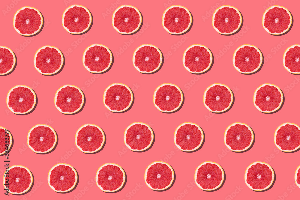 Fresh red orange or grapefruit on a peach color background.