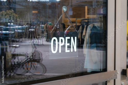  open sign on shop door - store window with open sign