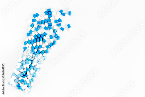 Creatine capsules. Pills scattered on white background top view