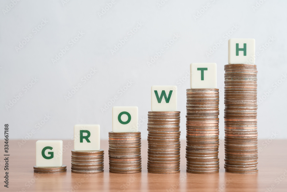 Business and finance growth concept. Green word GROWTH on stack step coins as graph rising up. Success performance or achieve KPI target plan and business strategy. Business and finance growth concept. Green word GROWTH on stack step coins as graph rising up. Success performance or achieve KPI target plan and business strategy.