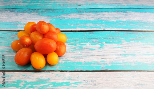 Variety colored of tomato cherry on top wooden table. Tomato cherry is packed with vitamin C, a cherry tomato boosts immunity and acts as an antioxidant photo